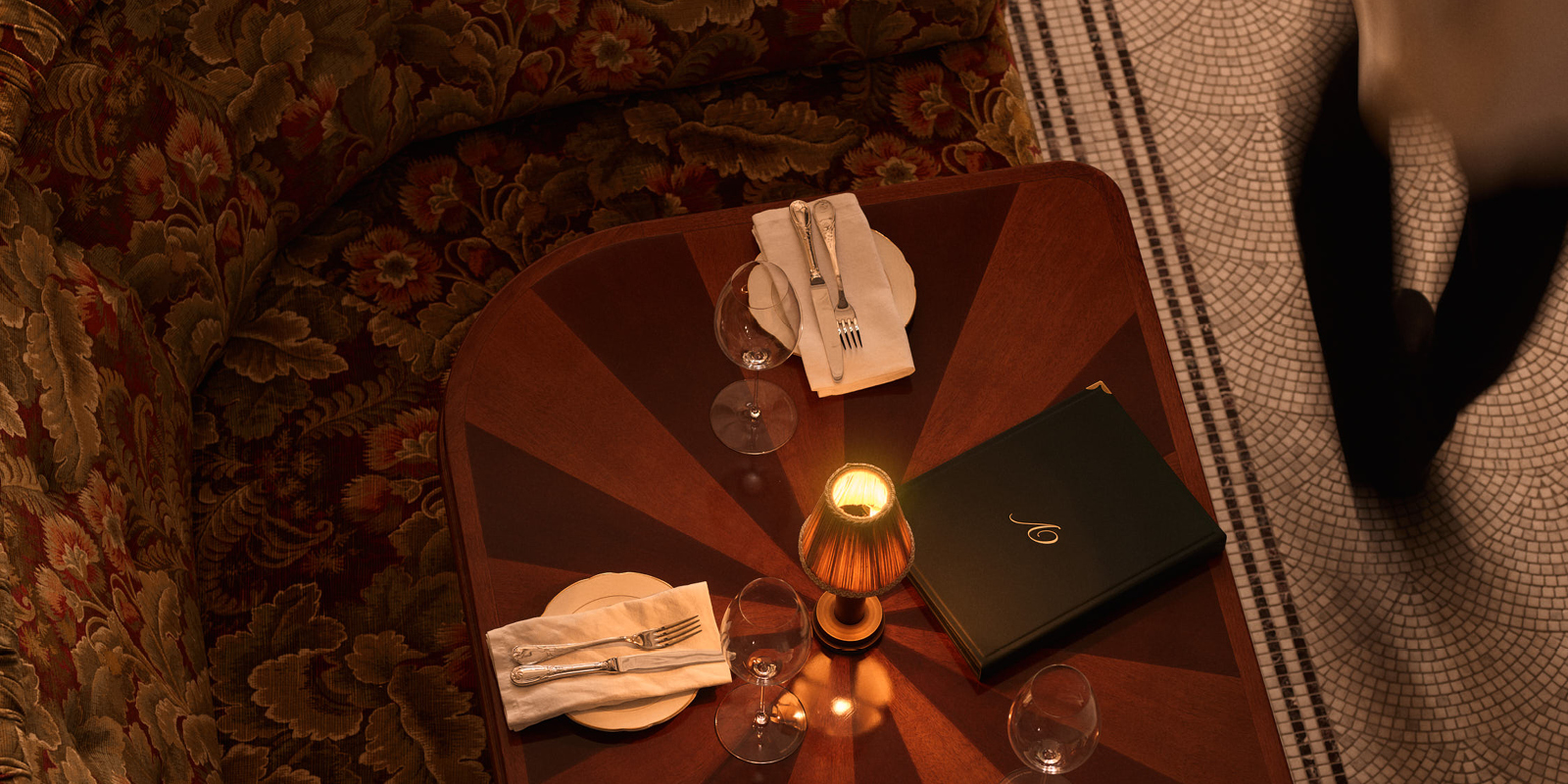 A lamp-lit booth table set for dinner at Vito's, Sydney CBD